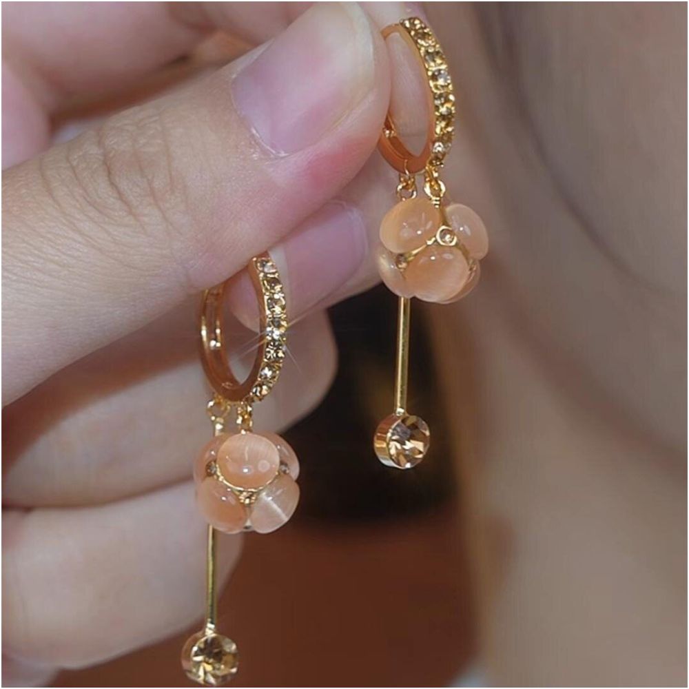 Spring and summer new cat eye stone ball tassel earrings for women with a high end feel micro inlaid ear buckles light luxury temperament face slimming earrings image 1